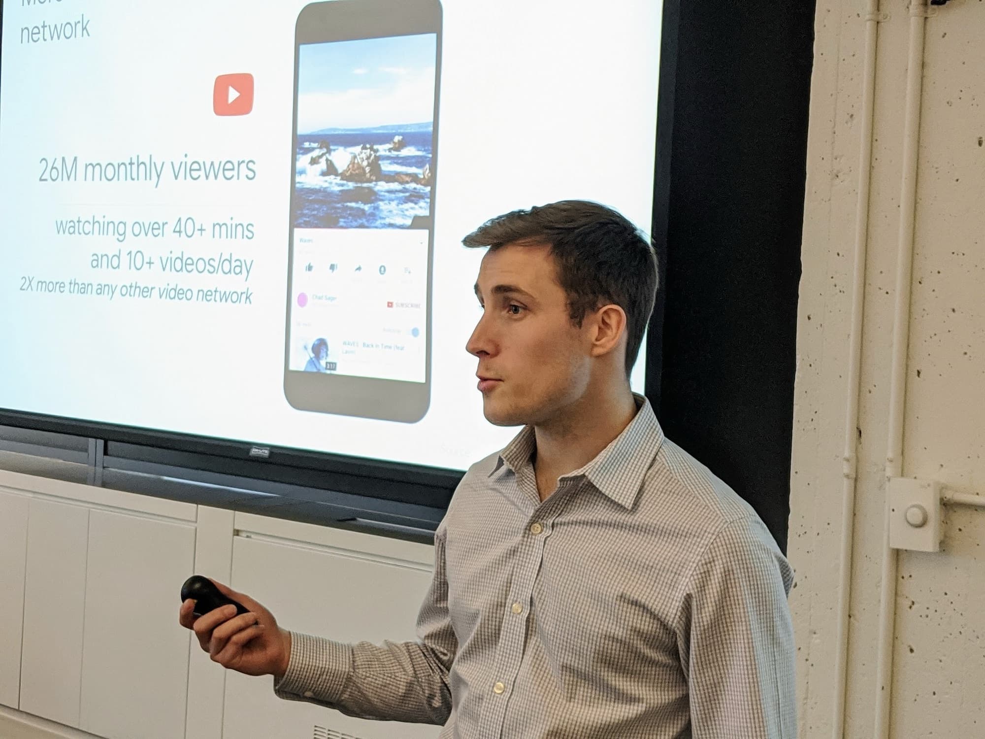 Paul Worrell presenting to a room, gesturing at a slide